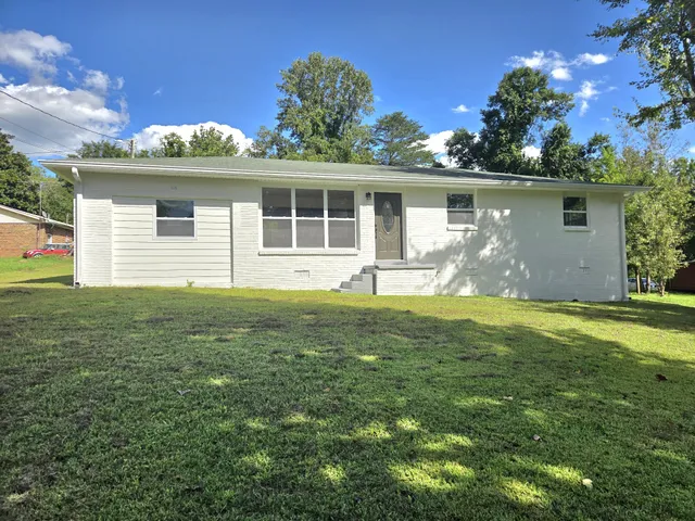 a front view of house with yard and green space