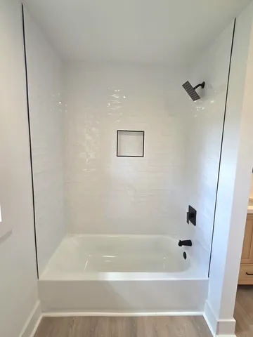 a close up view of a bathtub in shower