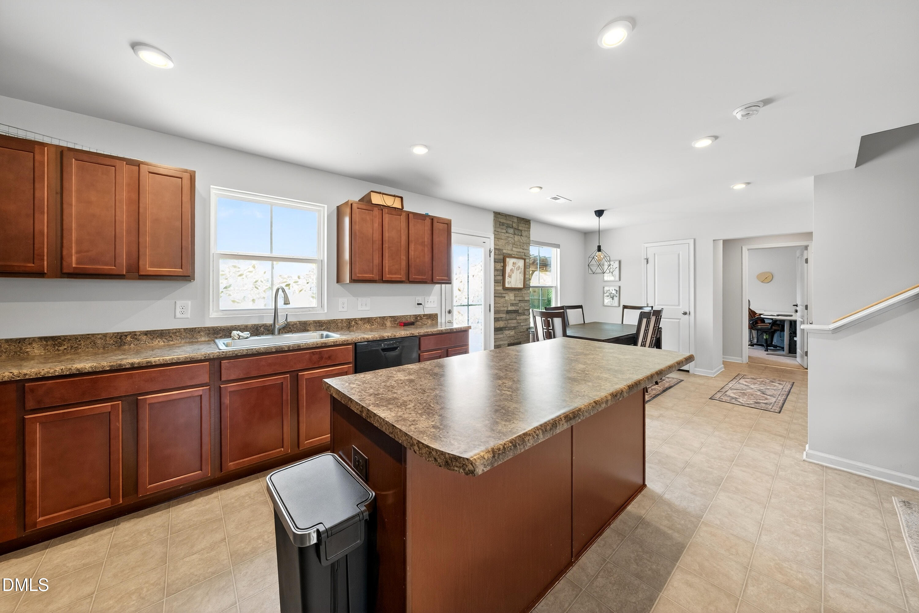 125 Donatella Way Angier, NC 27501 - Photo 4 of 10 a kitchen with kitchen island granite countertop a sink counter and chairs