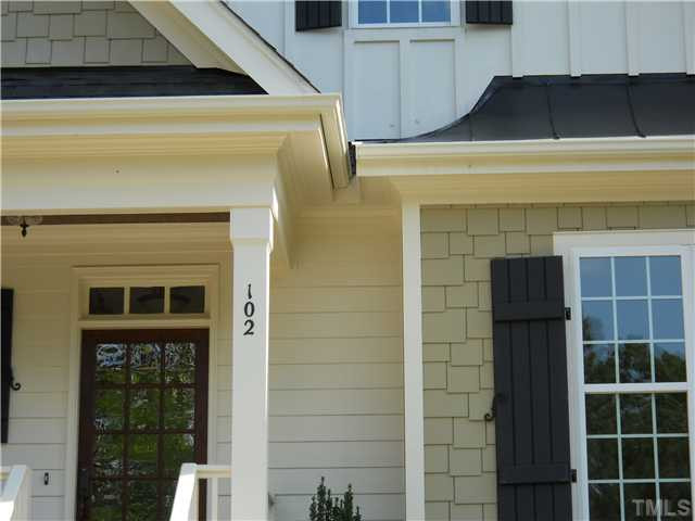2603 Wayland Drive, Unit 102 Raleigh, NC 27608 - Photo 2 of 11 Builder puts his love into his homes! Notice all the details... stained beadboard ceiling, heavy trim, 12-lite stained door w transom, shakes, standing seam accents, etc! Exterior Front