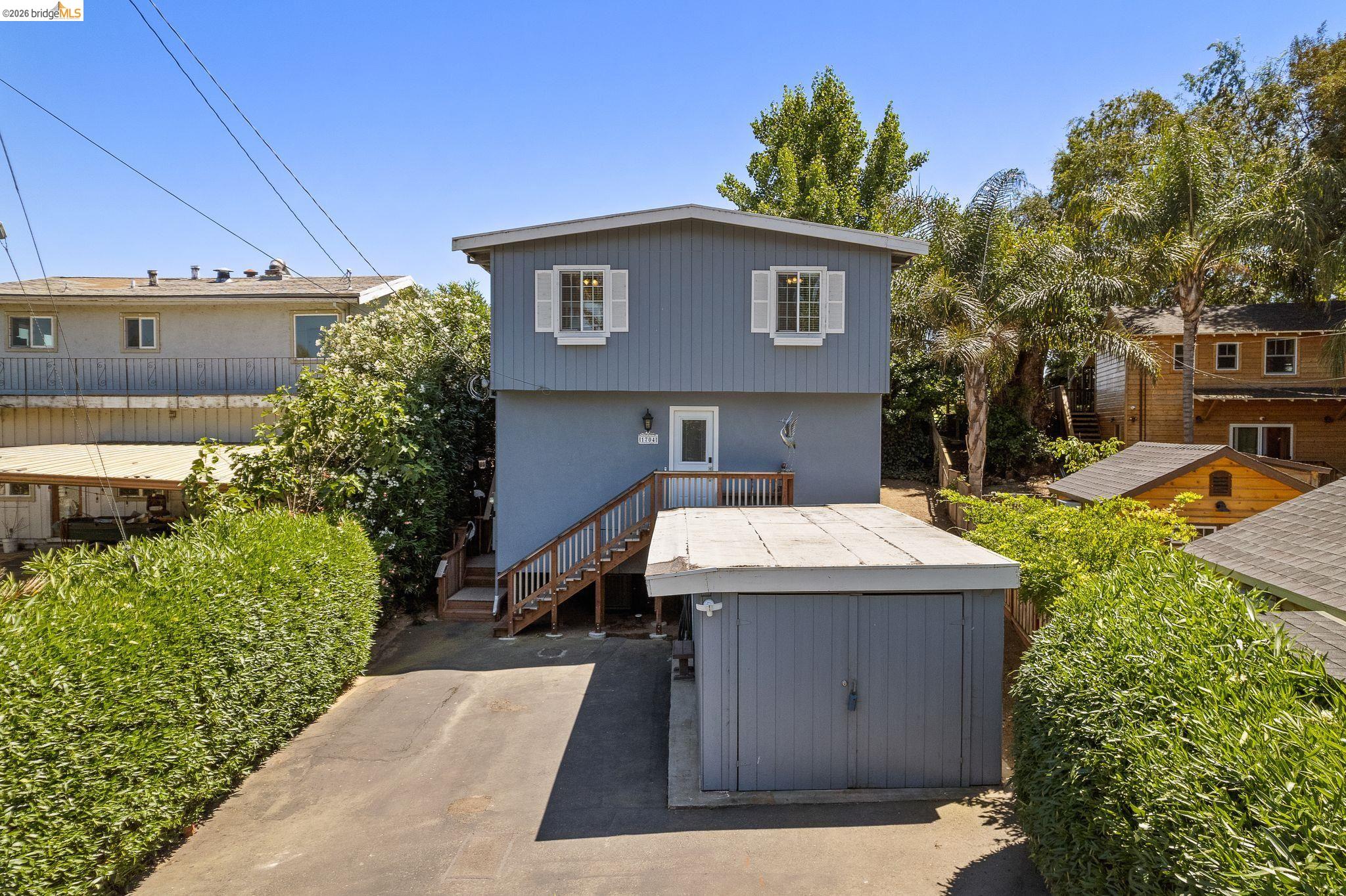 1704 Taylor Road Bethel Island, CA 94511 - Photo 7 of 73 Two-story residential structure featuring a gray exterior siding and white window shutters