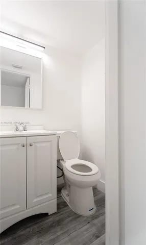 a white toilet sitting next to a bathroom sink
