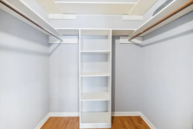 a view of walk in closet with empty racks