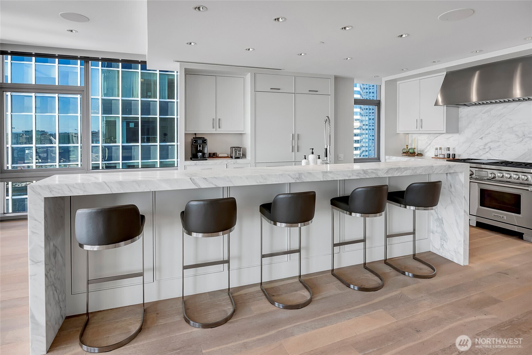 715 2nd Avenue, Unit 1702 Seattle, WA 98104 - Photo 14 of 38 a kitchen with a sink and chairs