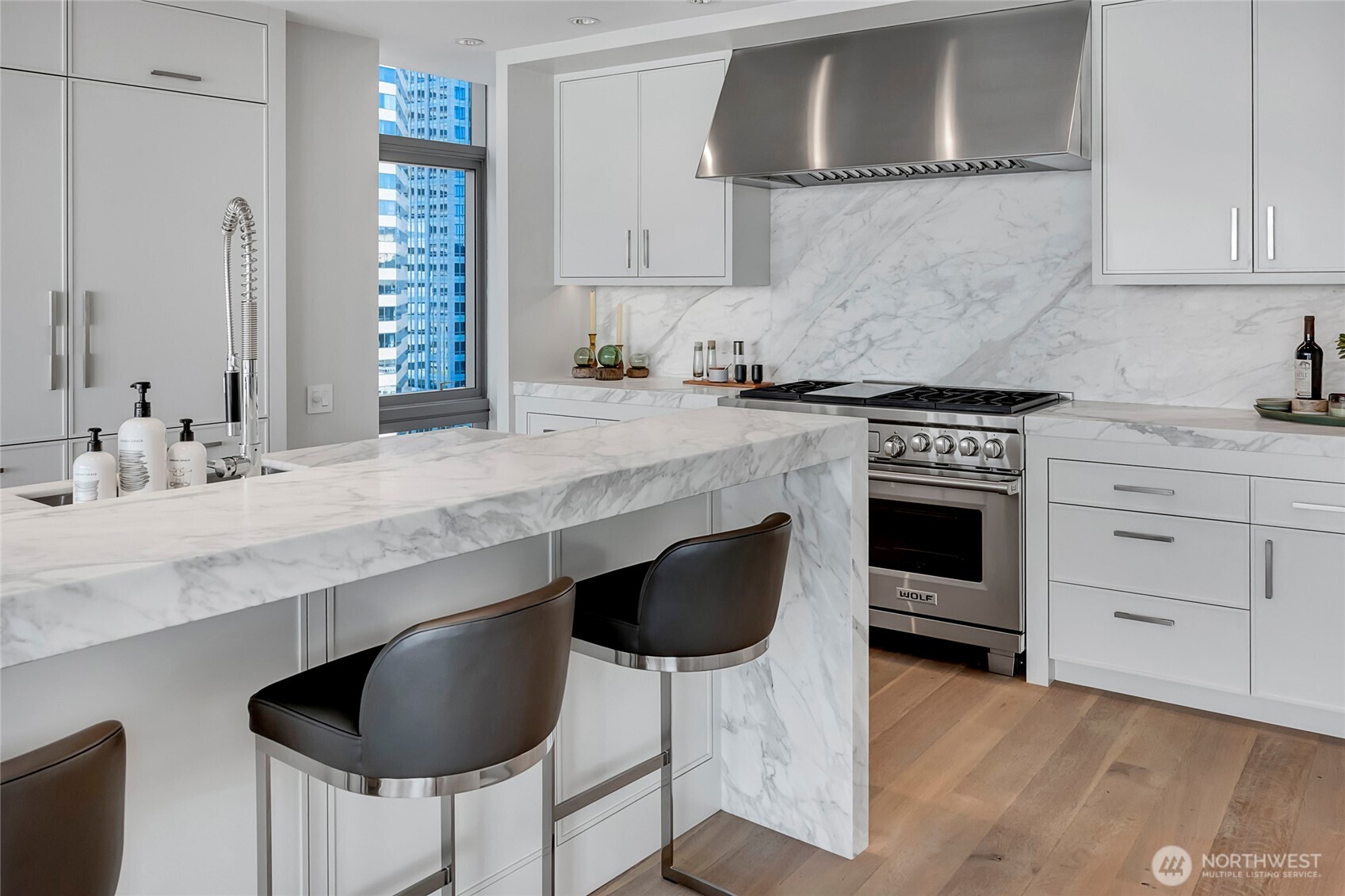 715 2nd Avenue, Unit 1702 Seattle, WA 98104 - Photo 16 of 38 a kitchen with granite countertop a sink cabinets and stainless steel appliances