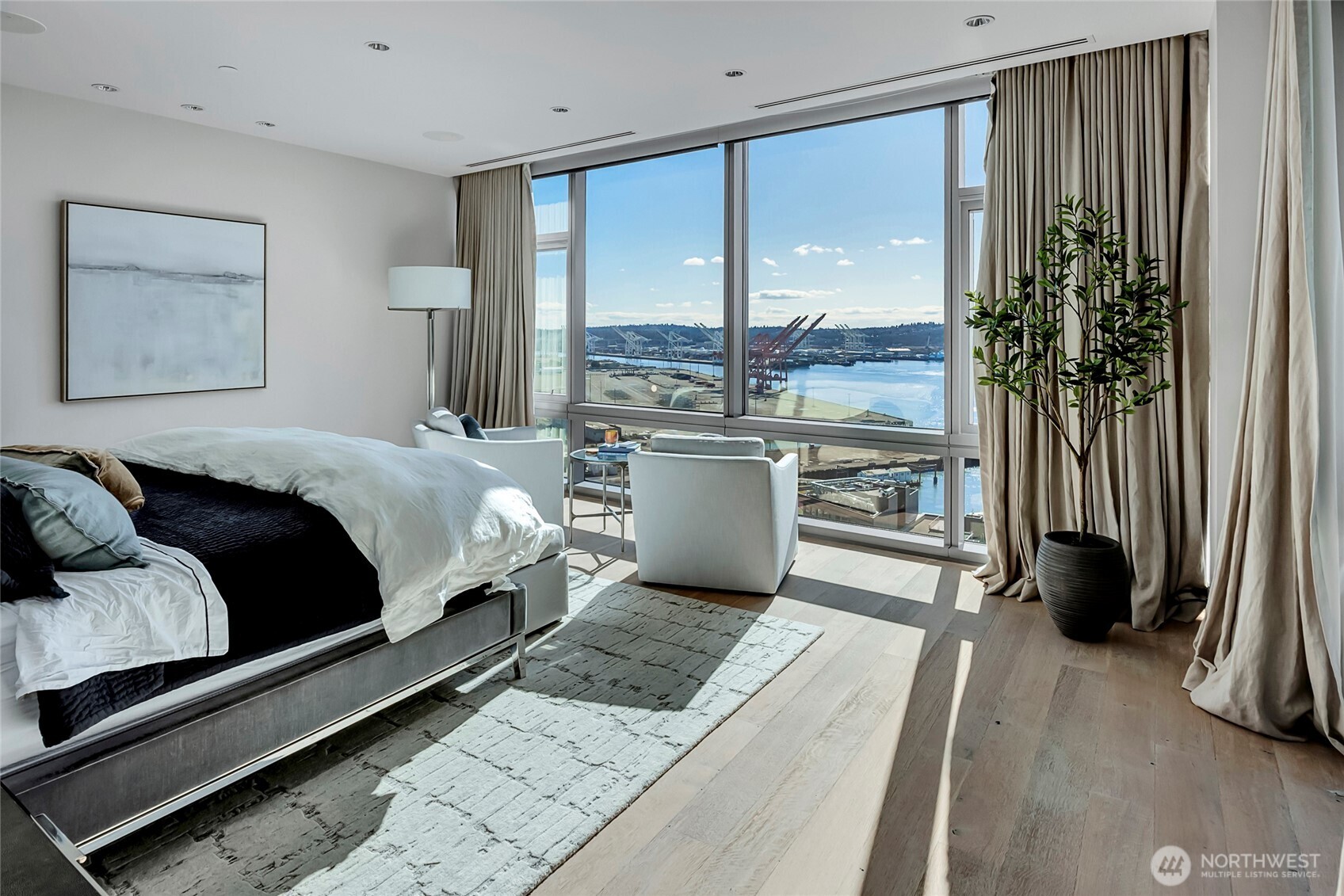 715 2nd Avenue, Unit 1702 Seattle, WA 98104 - Photo 20 of 38 a living room with a bed furniture and a large window