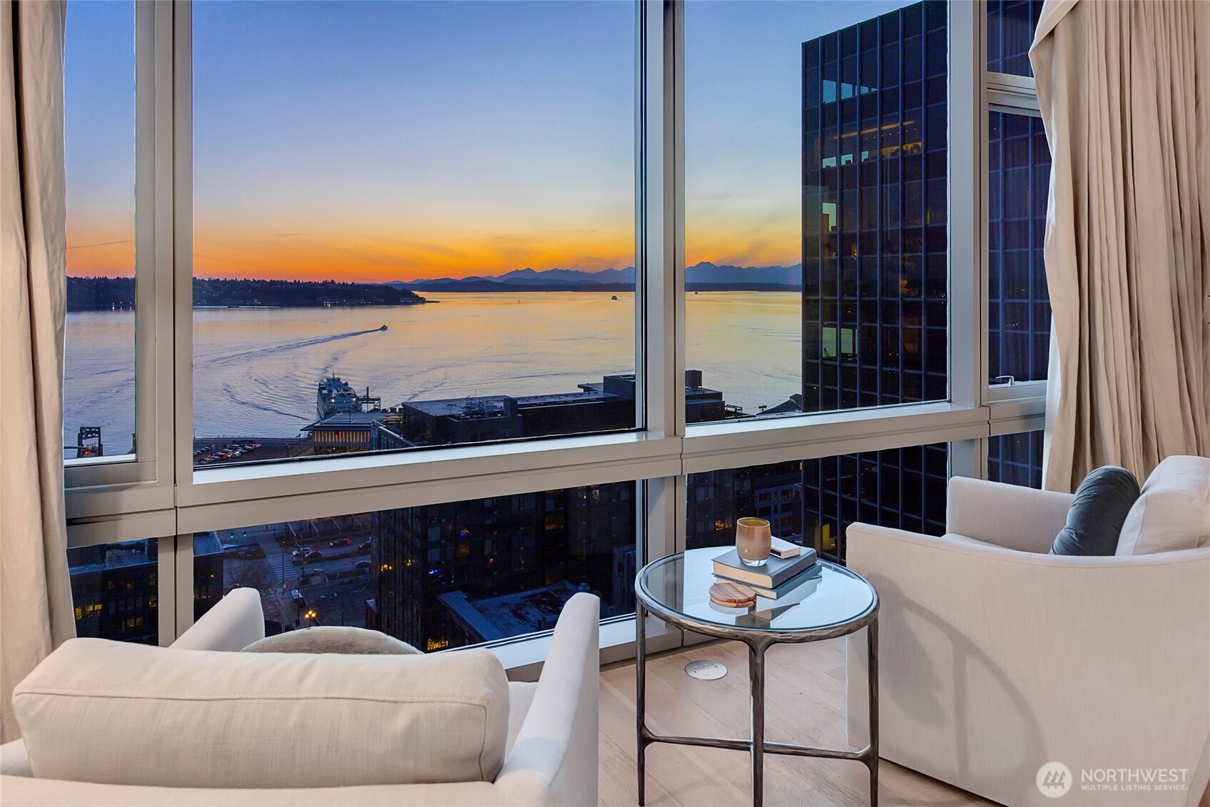 715 2nd Avenue, Unit 1702 Seattle, WA 98104 - Photo 23 of 38 a living room with furniture and a floor to ceiling window
