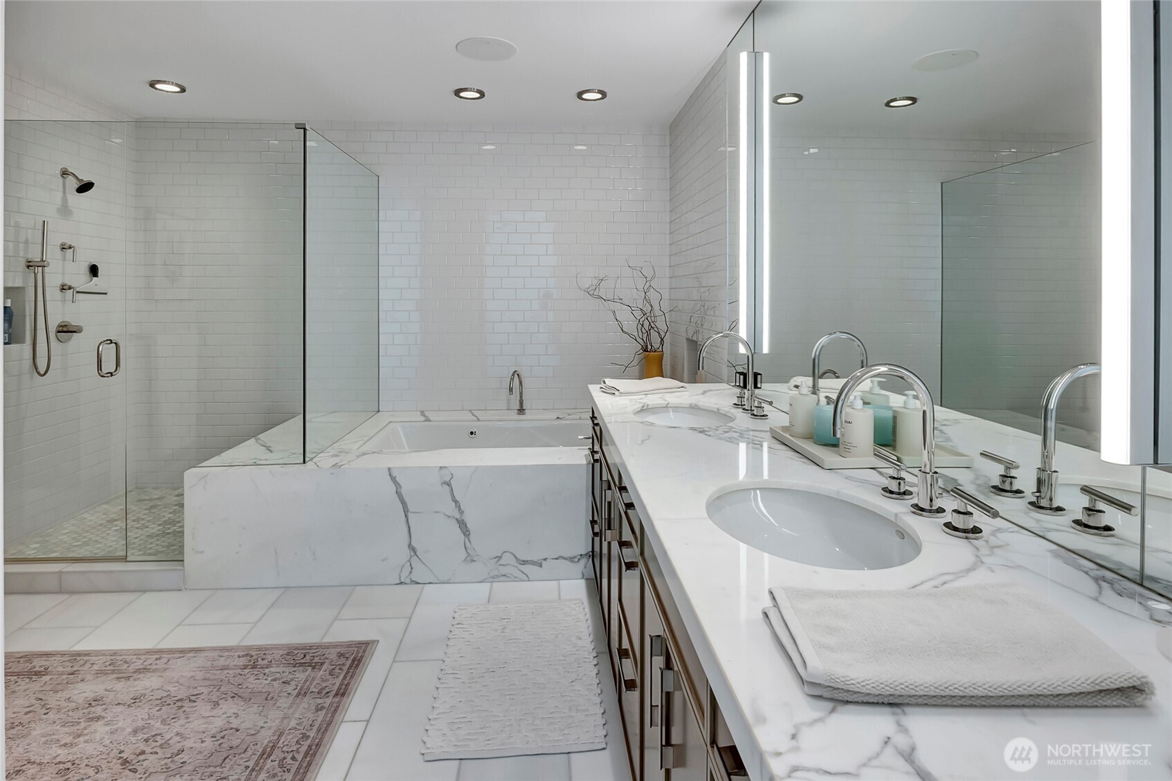 715 2nd Avenue, Unit 1702 Seattle, WA 98104 - Photo 24 of 38 a bathroom with a tub sink and mirror