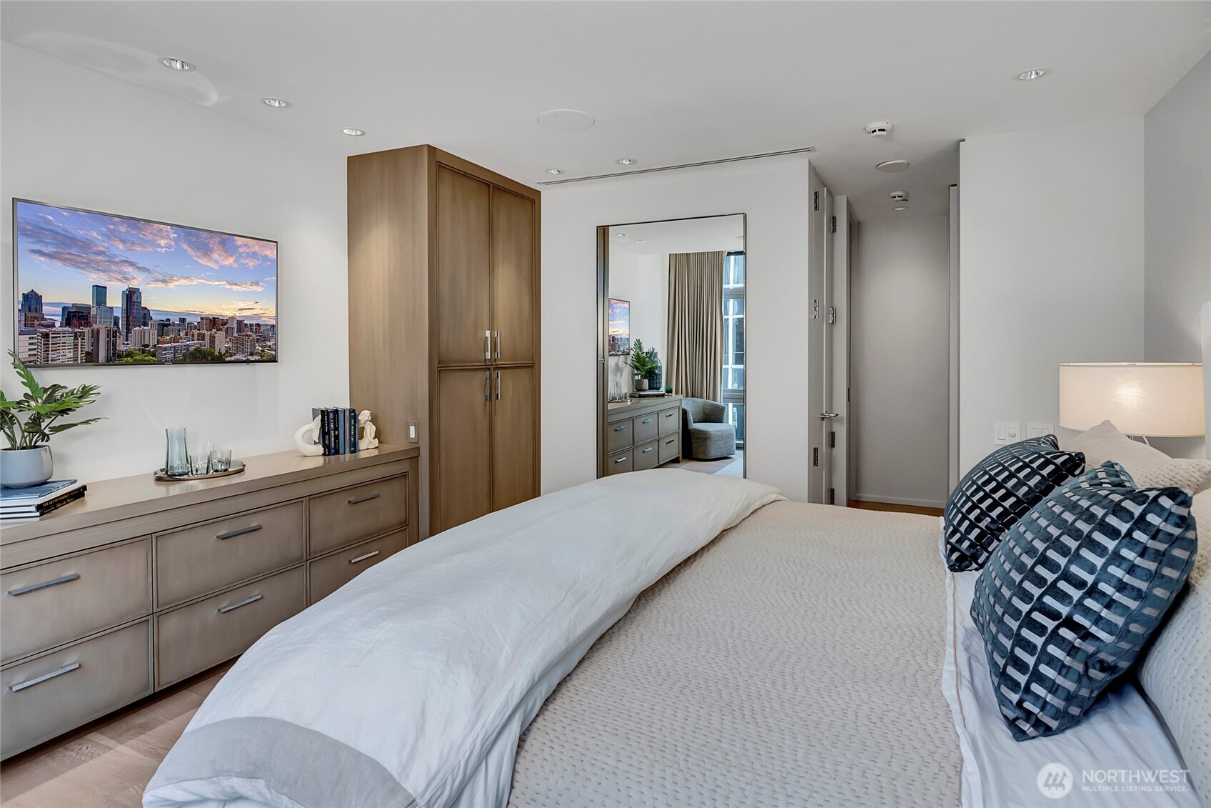 715 2nd Avenue, Unit 1702 Seattle, WA 98104 - Photo 30 of 38 a bedroom with a bed and a chandelier
