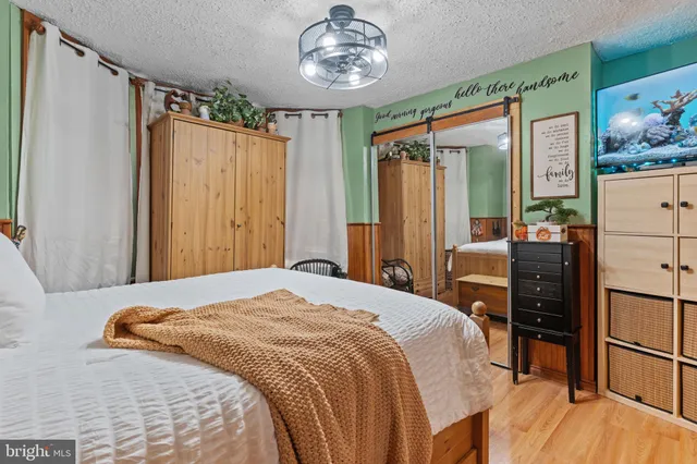 a bedroom with a bed dresser and a window