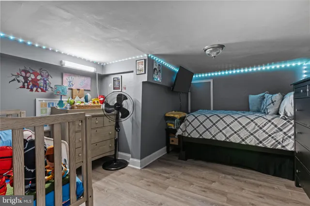 a bedroom with bed and wooden floor