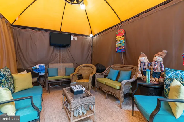 a outdoor living space with furniture and a fireplace