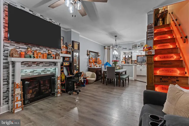a living room with furniture a flat screen tv and a fireplace