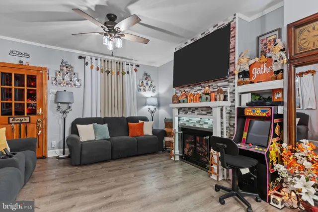 a living room with furniture a flat screen tv and a fireplace