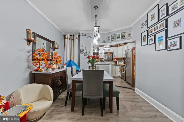 a view of a dining room with furniture and a chandelier