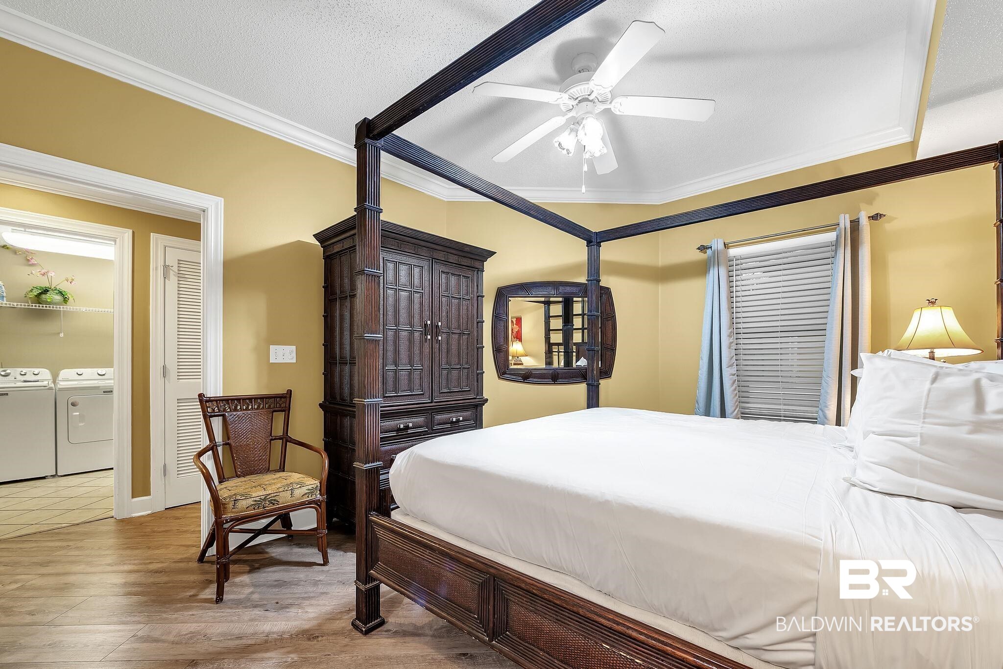 27580 Canal Road, Unit 1214 AND BOAT SLIP #62 Orange Beach, AL 36561 - Photo 27 of 67 Bedroom featuring light wood-style floors, independent washer and dryer, ornamental molding, and a ceiling fan