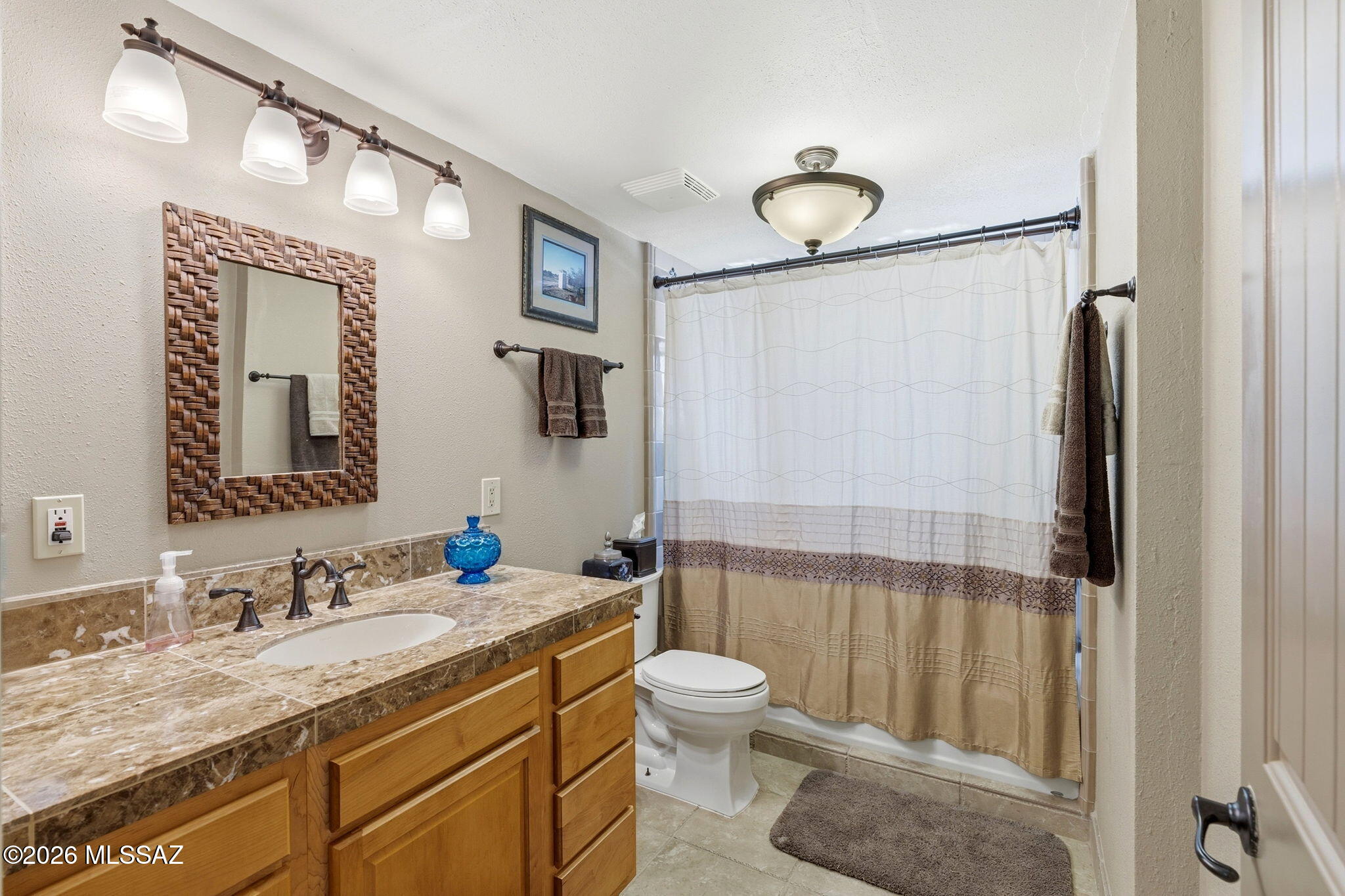 12810 West Gunsmoke Road Tucson, AZ 85736 - Photo 27 of 51 a bathroom with a granite countertop sink toilet and shower