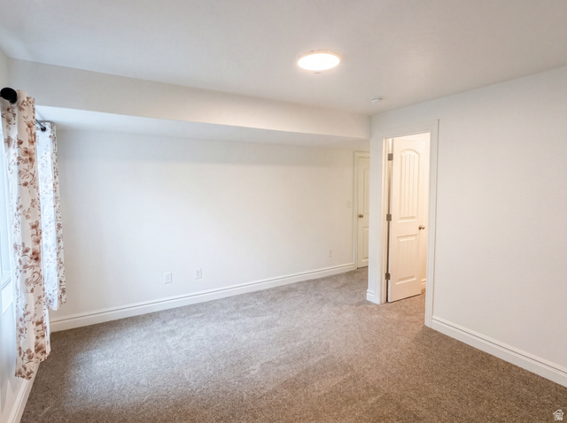 1251 North 2525 West Clinton, UT 84015 - Photo 15 of 30 Spacious room featuring neutral carpeting, white walls, recessed lighting, and a window with a curtain rod