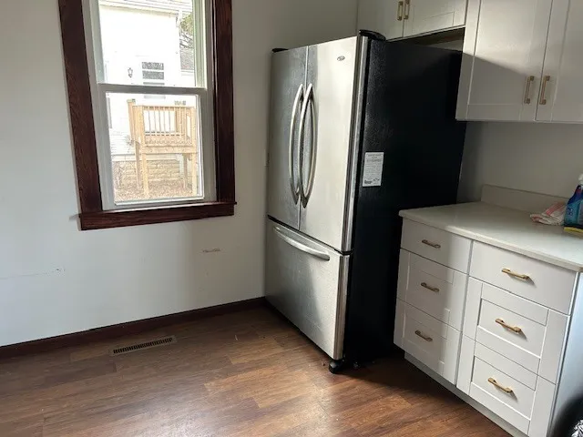 a kitchen with stainless steel appliances a refrigerator and a window