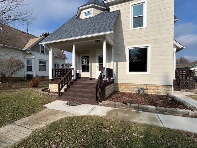 a view of a house with backyard porch and sitting area