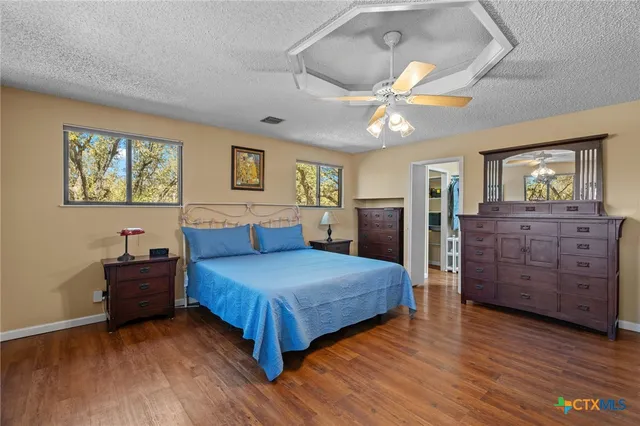 a spacious bedroom with a bed and a dresser