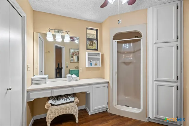 a bathroom with a sink a mirror and a shower