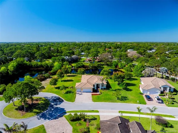 an aerial view of residential houses with outdoor space and street view