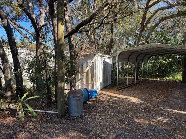 a view of a patio with furniture and a tree