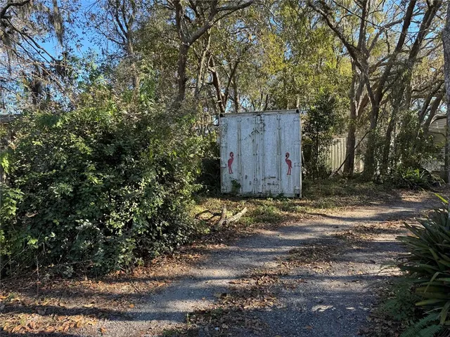 a wooden house with trees in front of it