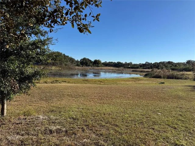 a view of a lake with houses in the back