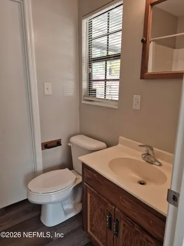 a white toilet sitting next to a bathroom sink