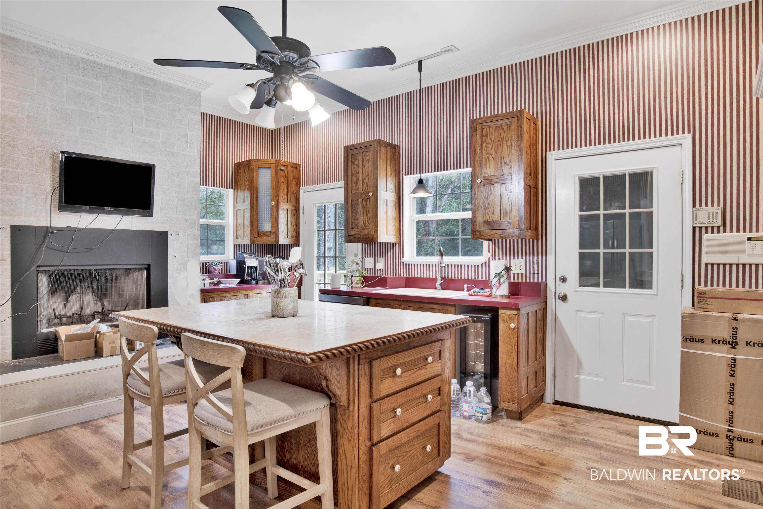 7641 Hitt Road Mobile, AL 36695 - Photo 10 of 29 Kitchen featuring crown molding, a wealth of natural light, ceiling fan, and light hardwood / wood-style floors