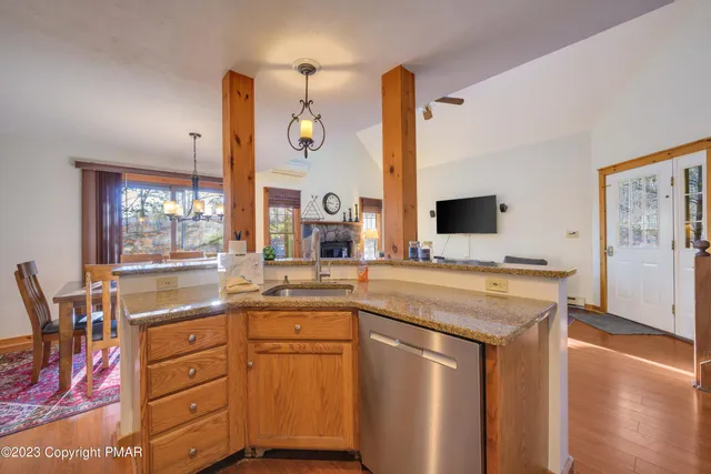 a kitchen with stainless steel appliances granite countertop a sink and a stove