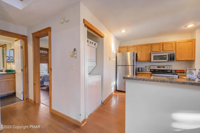 a kitchen with stainless steel appliances a refrigerator and a stove top oven