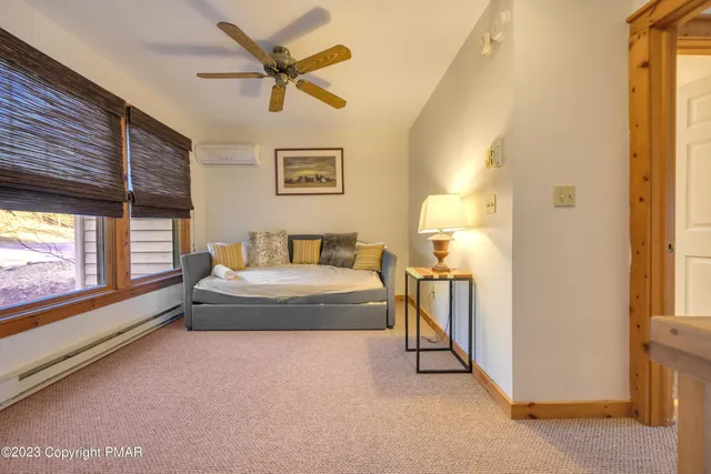 a spacious bedroom with a bed and a window