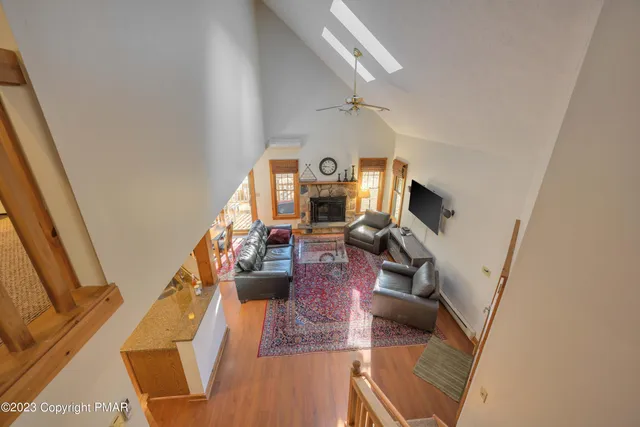 a view of a living room with furniture and a flat screen tv