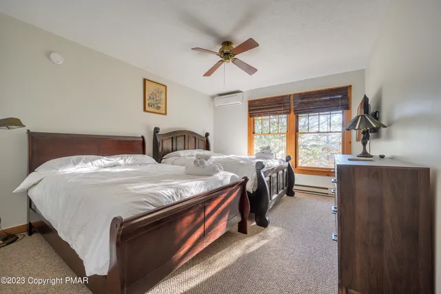 a spacious bedroom with a bed and a large window