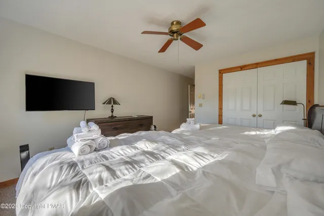 a bedroom with a bed and a flat screen tv