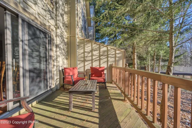 a view of balcony with wooden floor and outdoor seating