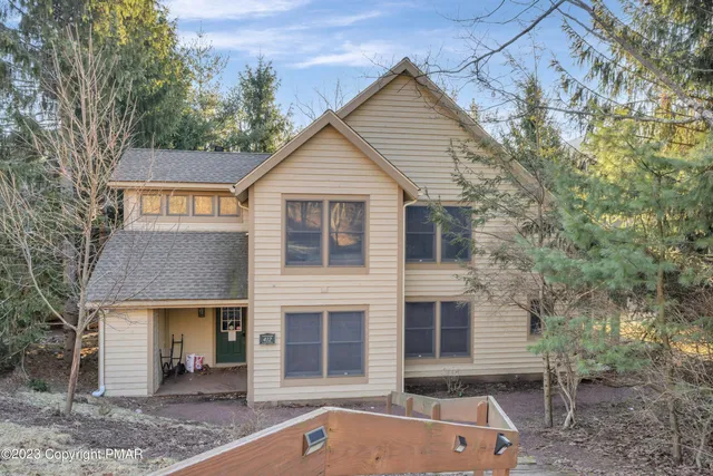 a view of house with a yard and sitting area