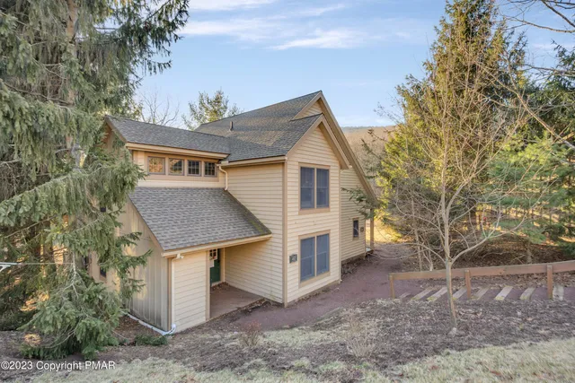 a view of a house with a yard and garage