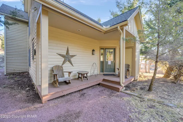 a view of a house with backyard and a chair