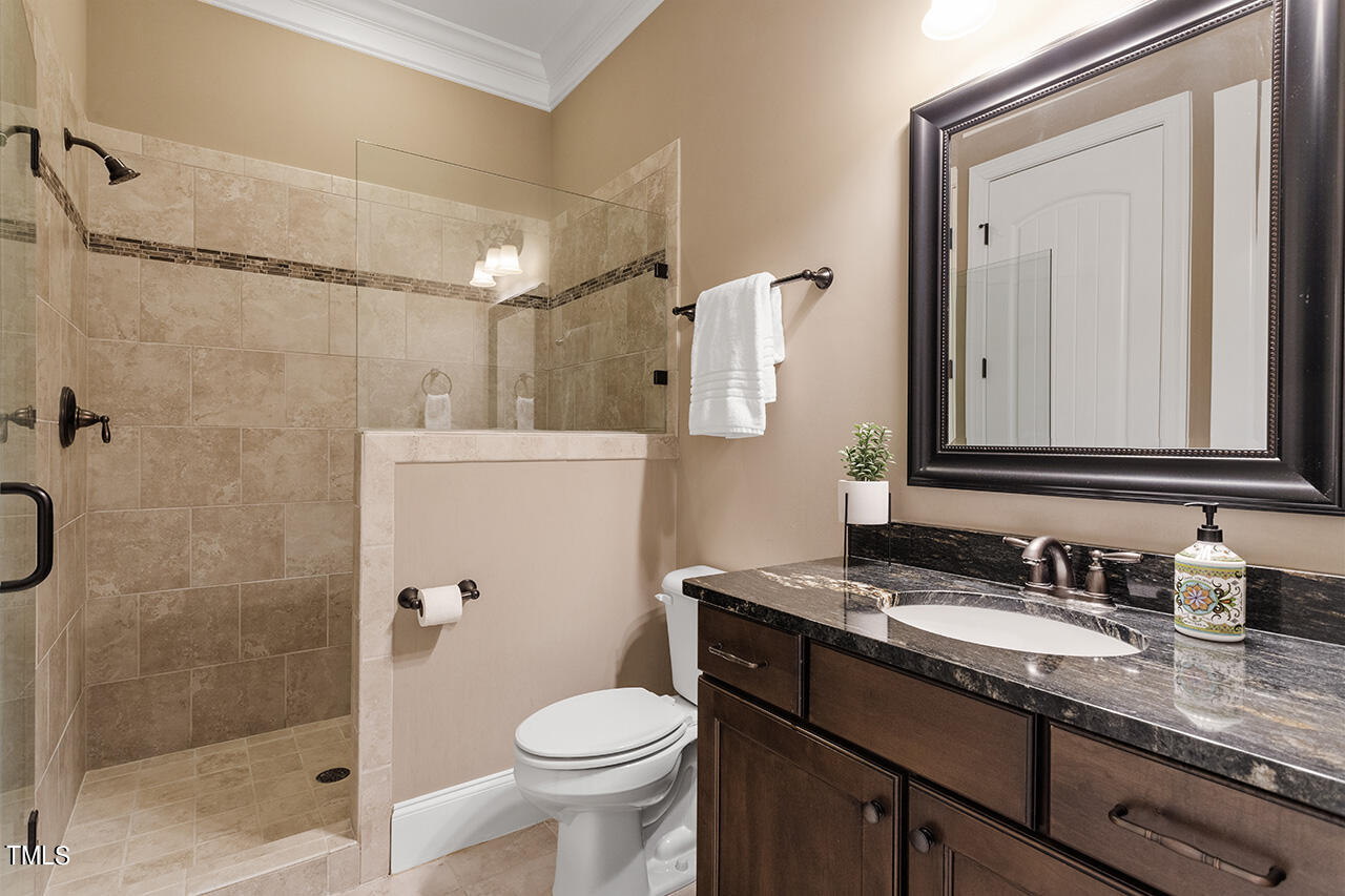 1036 Quiet Ridge Circle Raleigh, NC 27614 - Photo 25 of 60 a bathroom with a granite countertop sink toilet and shower