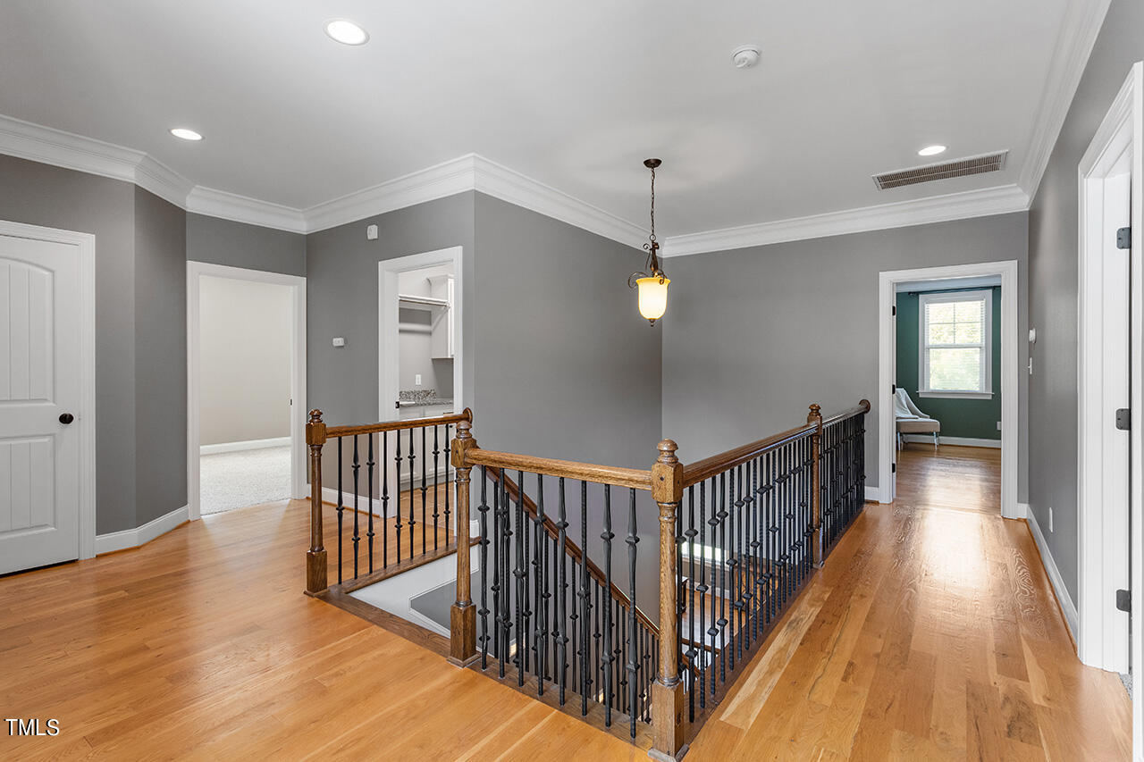 1036 Quiet Ridge Circle Raleigh, NC 27614 - Photo 35 of 60 a view of a hallway with wooden floor and staircase