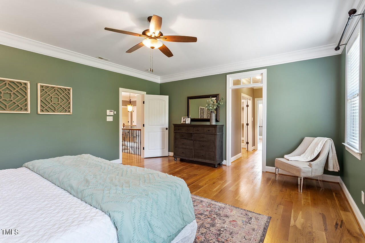 1036 Quiet Ridge Circle Raleigh, NC 27614 - Photo 39 of 60 a bedroom with a bed and a chandelier