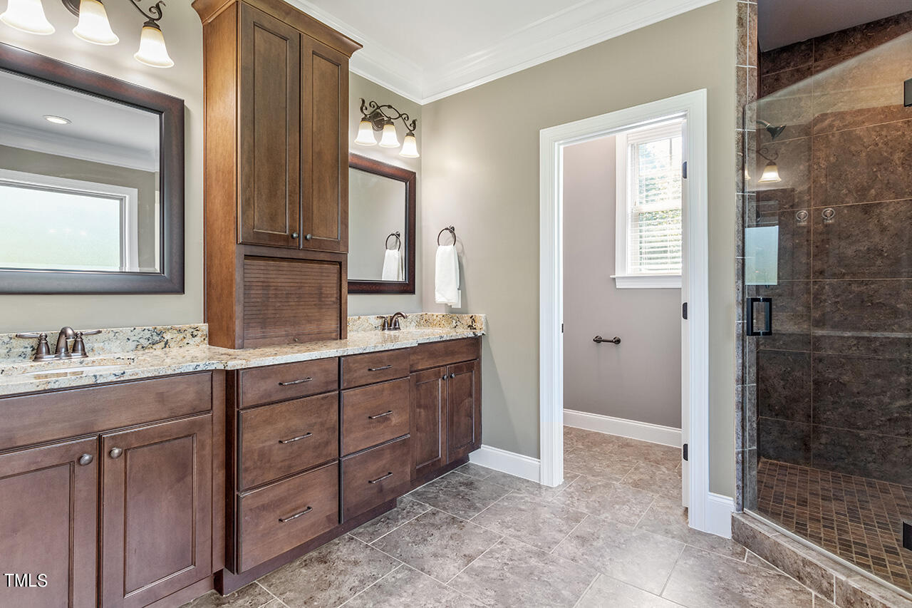 1036 Quiet Ridge Circle Raleigh, NC 27614 - Photo 43 of 60 a spacious bathroom with a granite countertop sink mirror and double