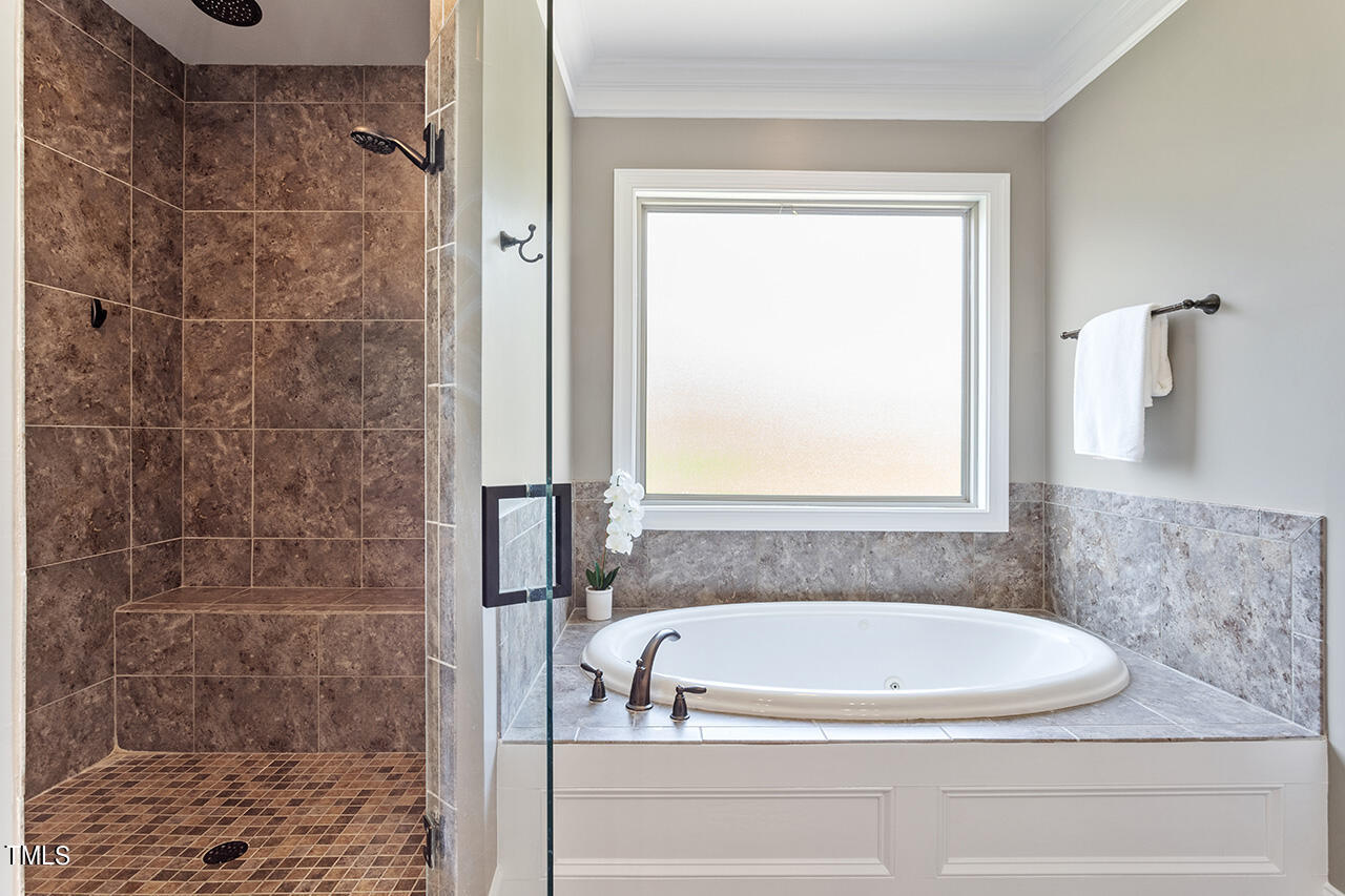 1036 Quiet Ridge Circle Raleigh, NC 27614 - Photo 44 of 60 a bathroom with a bathtub and shower
