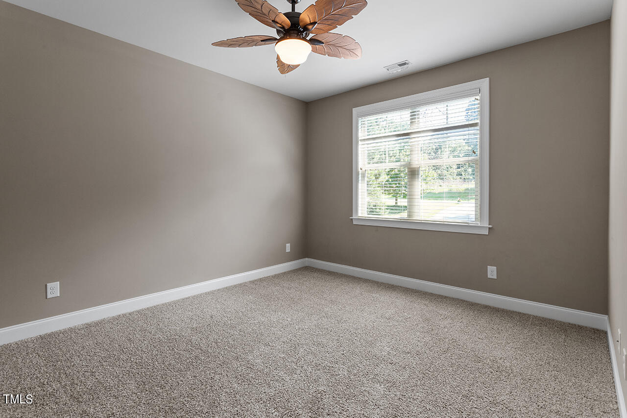 1036 Quiet Ridge Circle Raleigh, NC 27614 - Photo 48 of 60 an empty room with a window and a fan