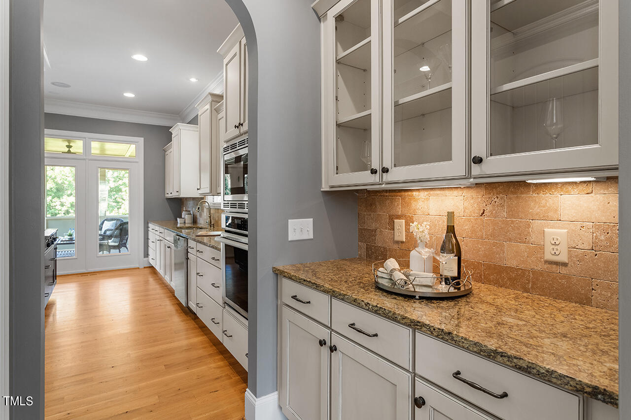 1036 Quiet Ridge Circle Raleigh, NC 27614 - Photo 10 of 60 a kitchen with granite countertop kitchen island white cabinets and white appliances