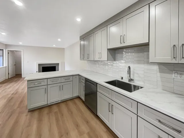 a kitchen with granite countertop a stove and a microwave